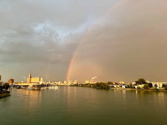 A rainbow over the river Rhine, photographed from the three-country-bridge near Basel